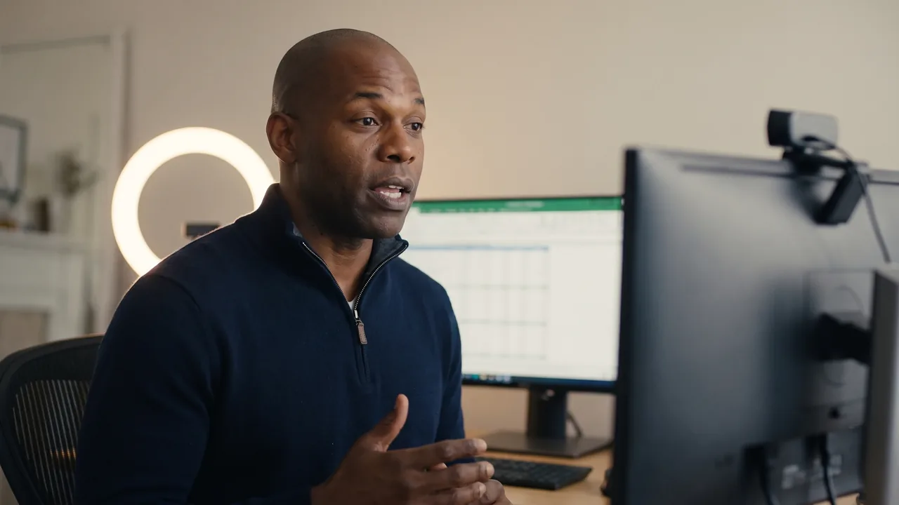 Jordan, the sales coach, at a standing desk in a home office, recording a screen share.